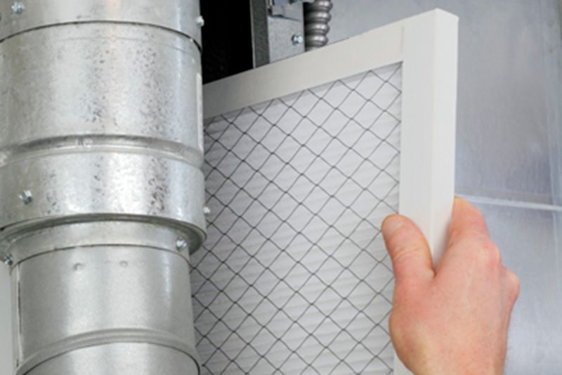 A furnace filter being installed. What Are Furnace Filters?