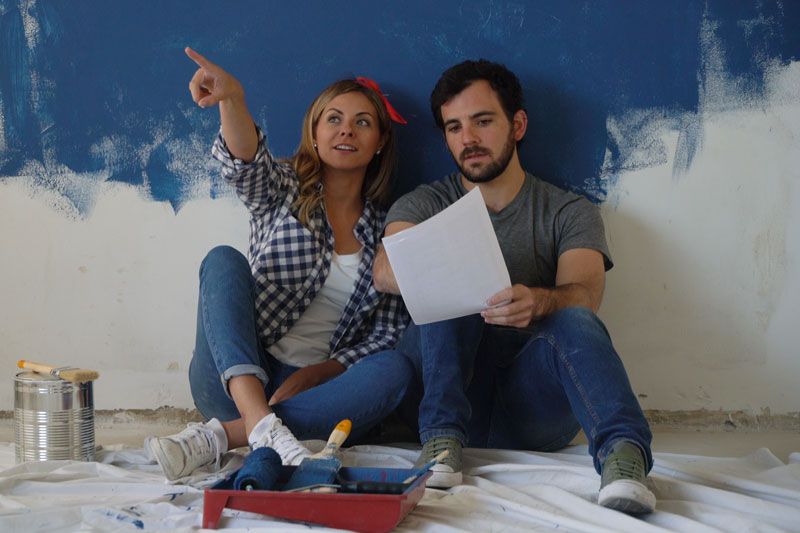 Image of couple sitting on the floor. Video - Remodeling Your Home? Don’t Forget Your Comfort!